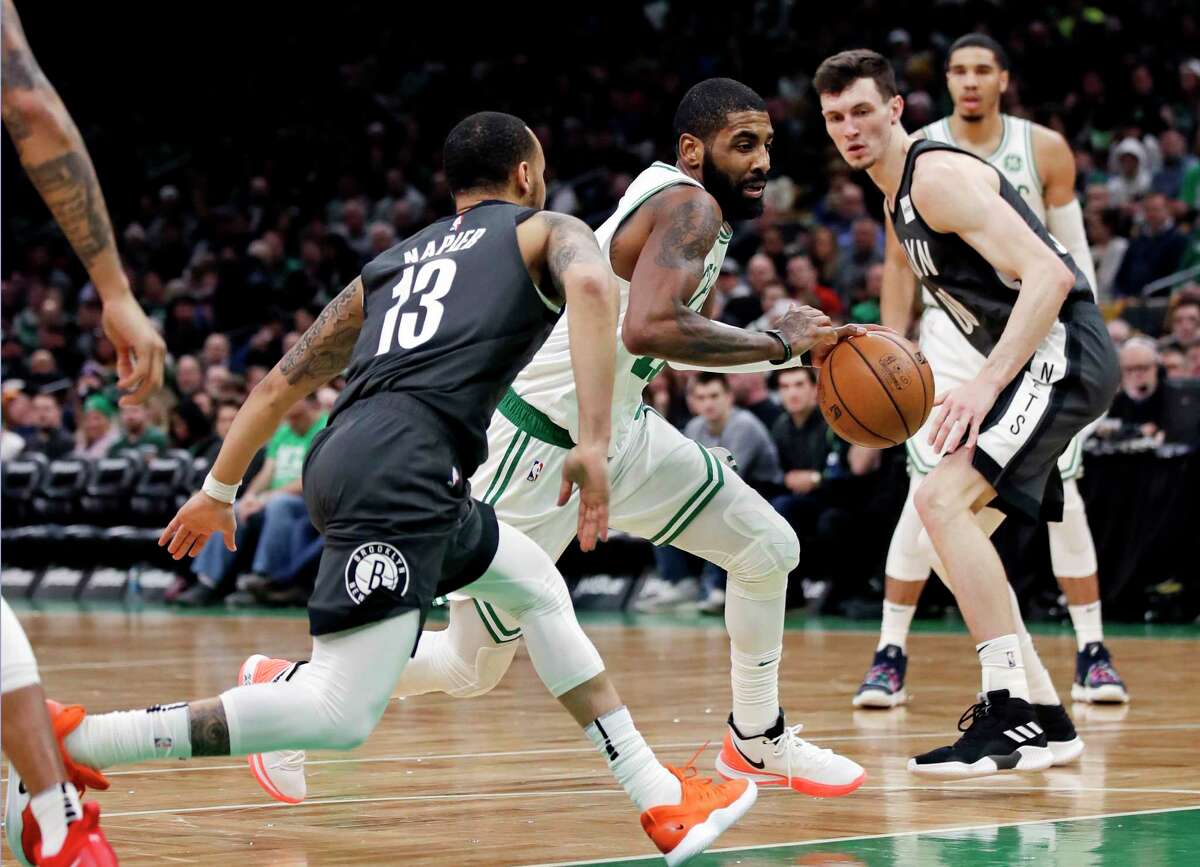 Brooklyn Nets guard Kyrie Irving, center left, and forward Kevin