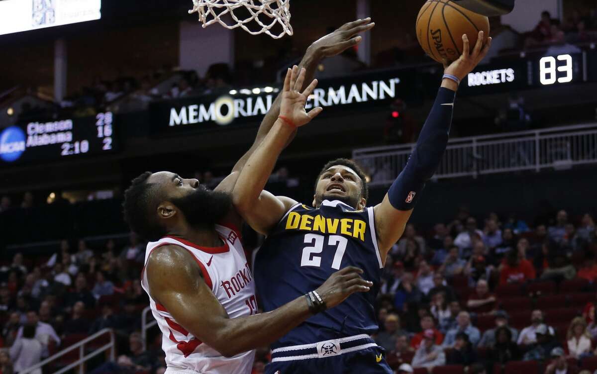 HOUSTON, TEXAS - JANUARY 07: Jamal Murray #27 of the Denver Nuggets is fouled by James Harden #13 of the Houston Rockets as he drives to the basket during the third quarter at Toyota Center on January 07, 2019 in Houston, Texas.  (Photo by Bob Levey/Getty Images)