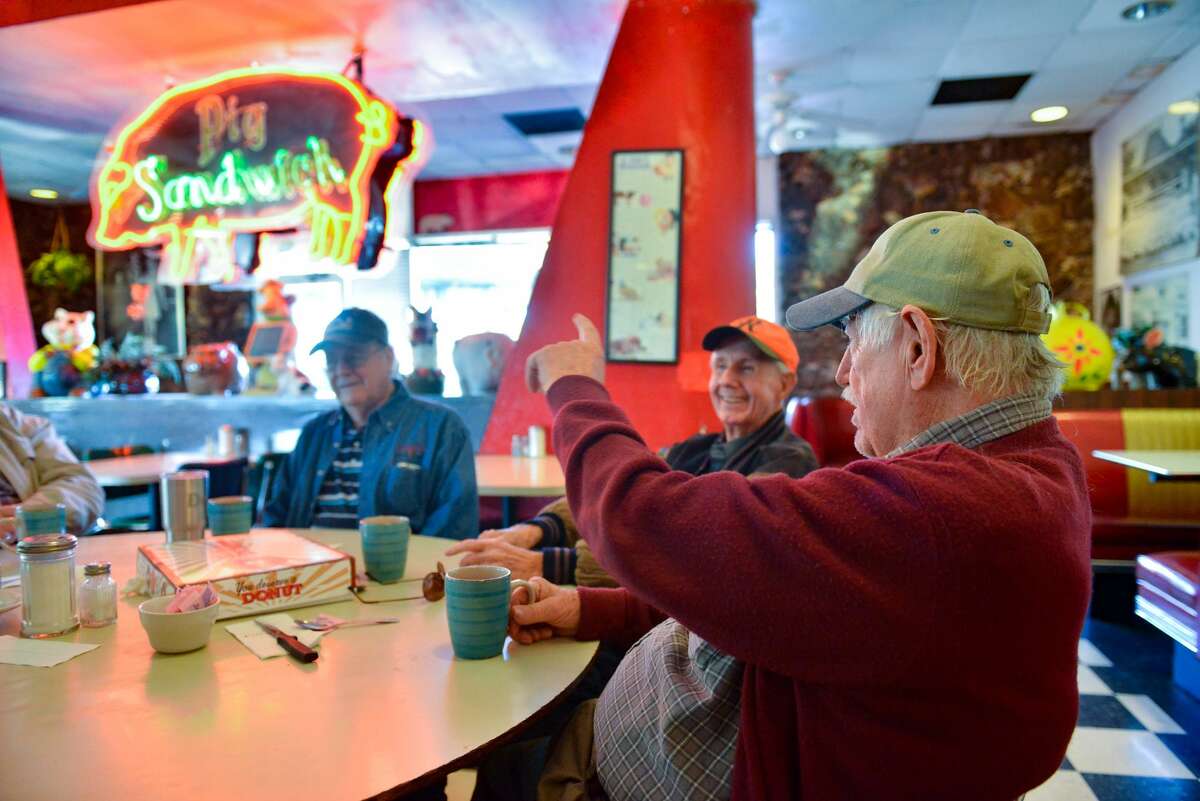 Richard Roe (right to left), Gerald Hewitt and Dean Williams talk during breakfast at the old-school Pig Stand diner.