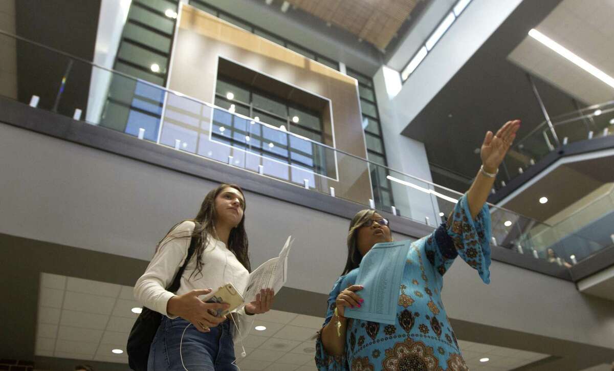 Katherine Tugwell gets directions from school counselor Valeria Fuller as Grand Oaks High School opens its doors for the first time on Wednesday, Aug. 15, 2018, in Spring.