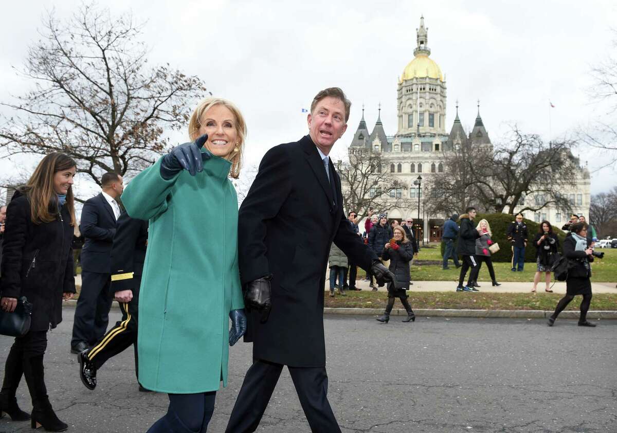 Governor Ned Lamont and his wife, Ann, walk in a parade outside of the Capitol Building in Hartford after he was sworn into office on January 9, 2019.