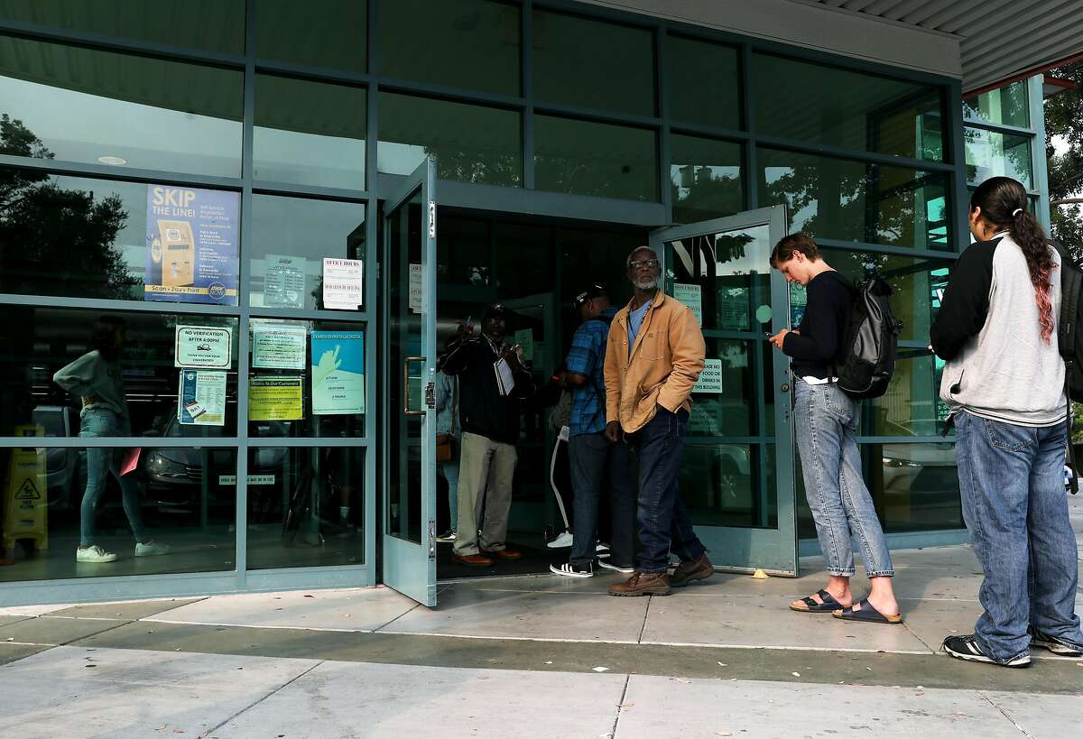 People stand in line at the DMV, at 5300 Claremont Ave. in Oakland, Cali., on Tuesday, August 7, 2018.