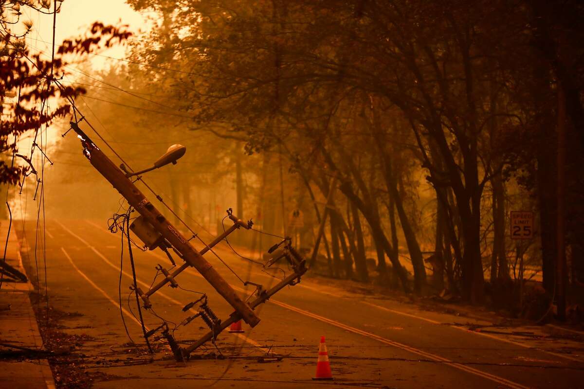 A downed utility pole off of Elliott Road after the Camp Fire tore through the town of Paradise, California, on Friday, Nov. 9, 2018.