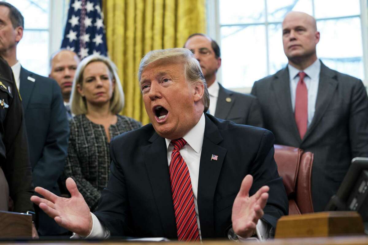 President Donald Trump at the signing ceremony for the Frederick Douglass Trafficking Victims Prevention and Protection Reauthorization Act, in the Oval Office of the White House, in Washington, Jan. 9, 2019. Wednesday also marked the 19th day of a partial government shutdown. Third from left is Homeland Security Secretary Kirstjen Nielsen, and at right is Acting Attorney General Matthew Whitaker. (Doug Mills/The New York Times)