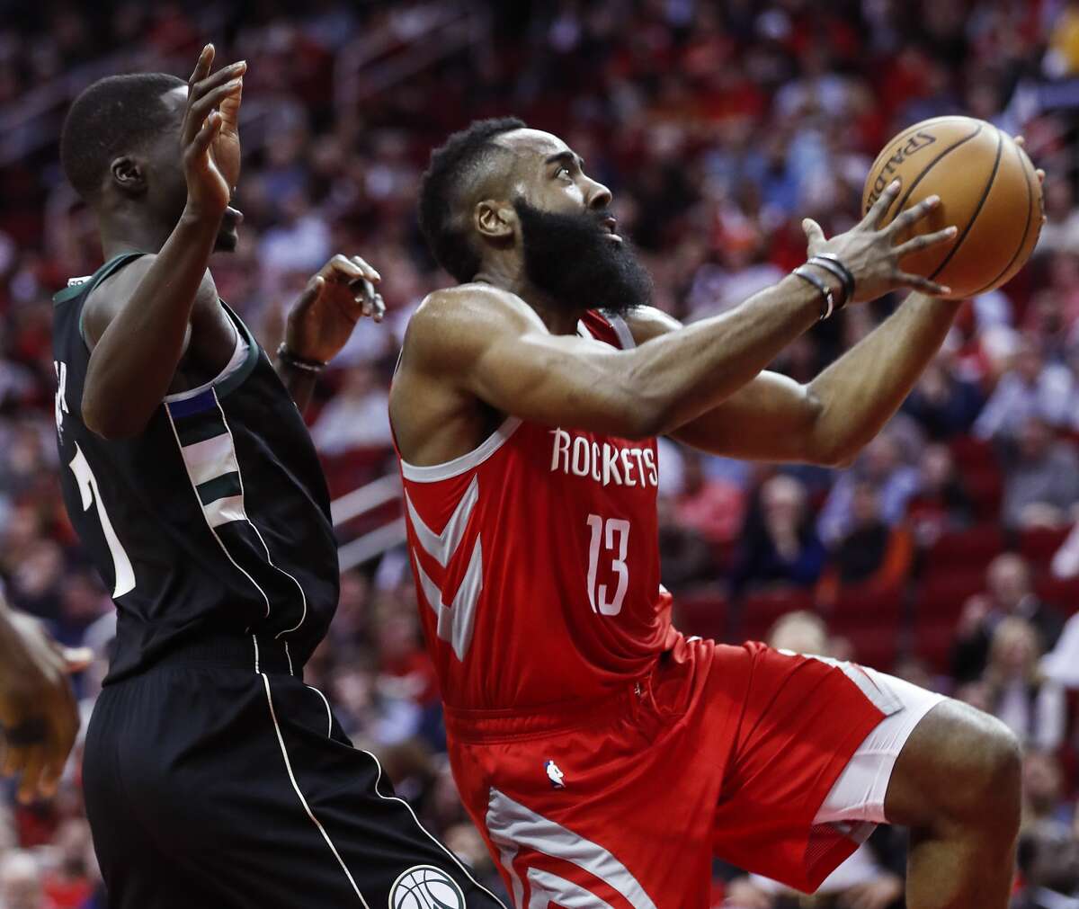 Houston Rockets guard James Harden (13) drives to the basket past Milwaukee Bucks forward Thon Maker (7) during the first half of an NBA basketball game at Toyota Center on Wednesday, Jan. 9, 2019, in Houston.