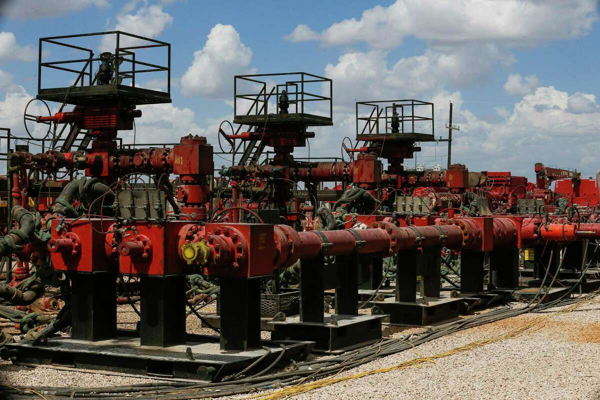 Pressure pumps wait for hydraulic fracturing operations to begin at a Chevron drilling site in the Permian Basin. Oil majors are surpassing independents in improving shale production.