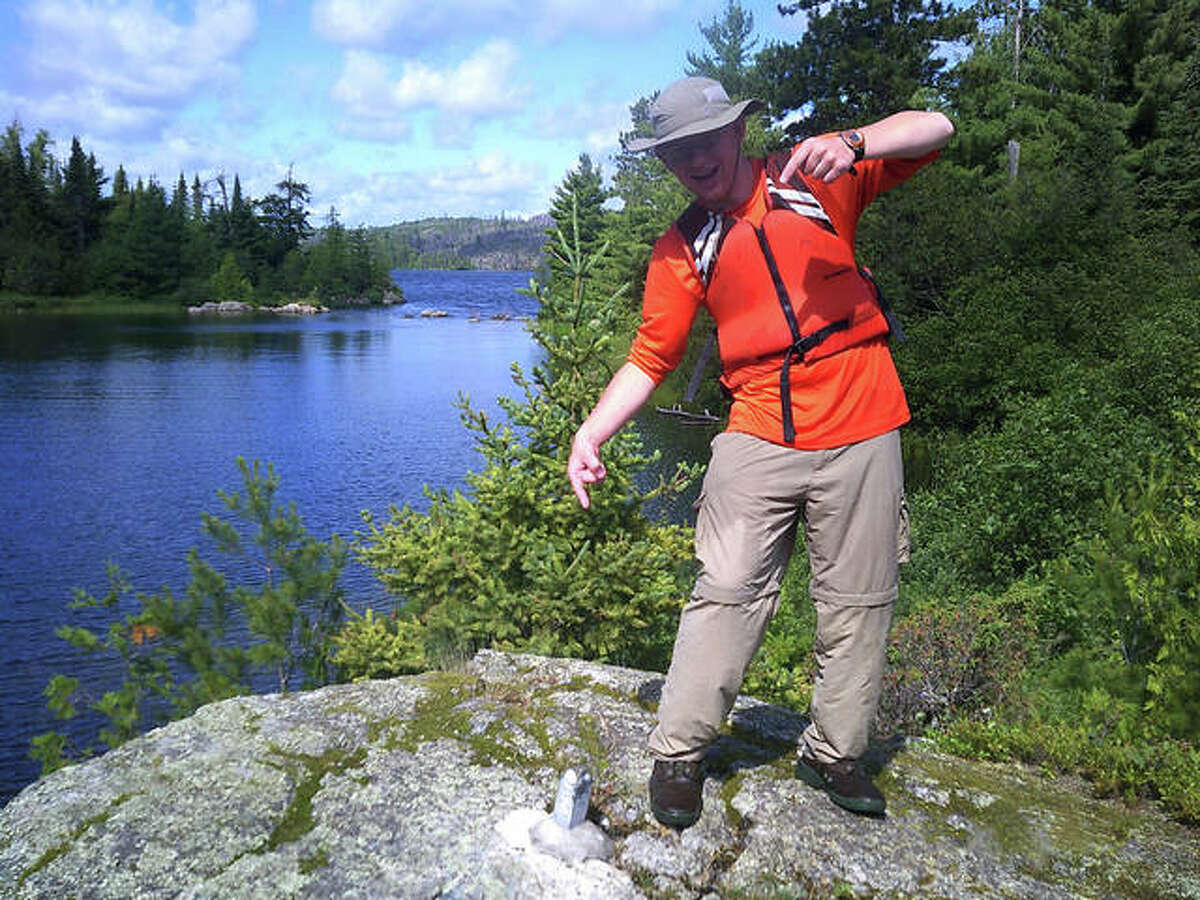 A boy scout of Edwardsville Troop 31 points to a survey marker designating the US/Canadian border following a recent 110-mile canoe trip in boundary waters. A currently forming girl’s group, Troop 27, will be able to experience similar adventures through Boy Scouts of America’s new Scouts BSA program. Troop 31 is preparing to be a “sister” group to Troop 27 under the initiative.