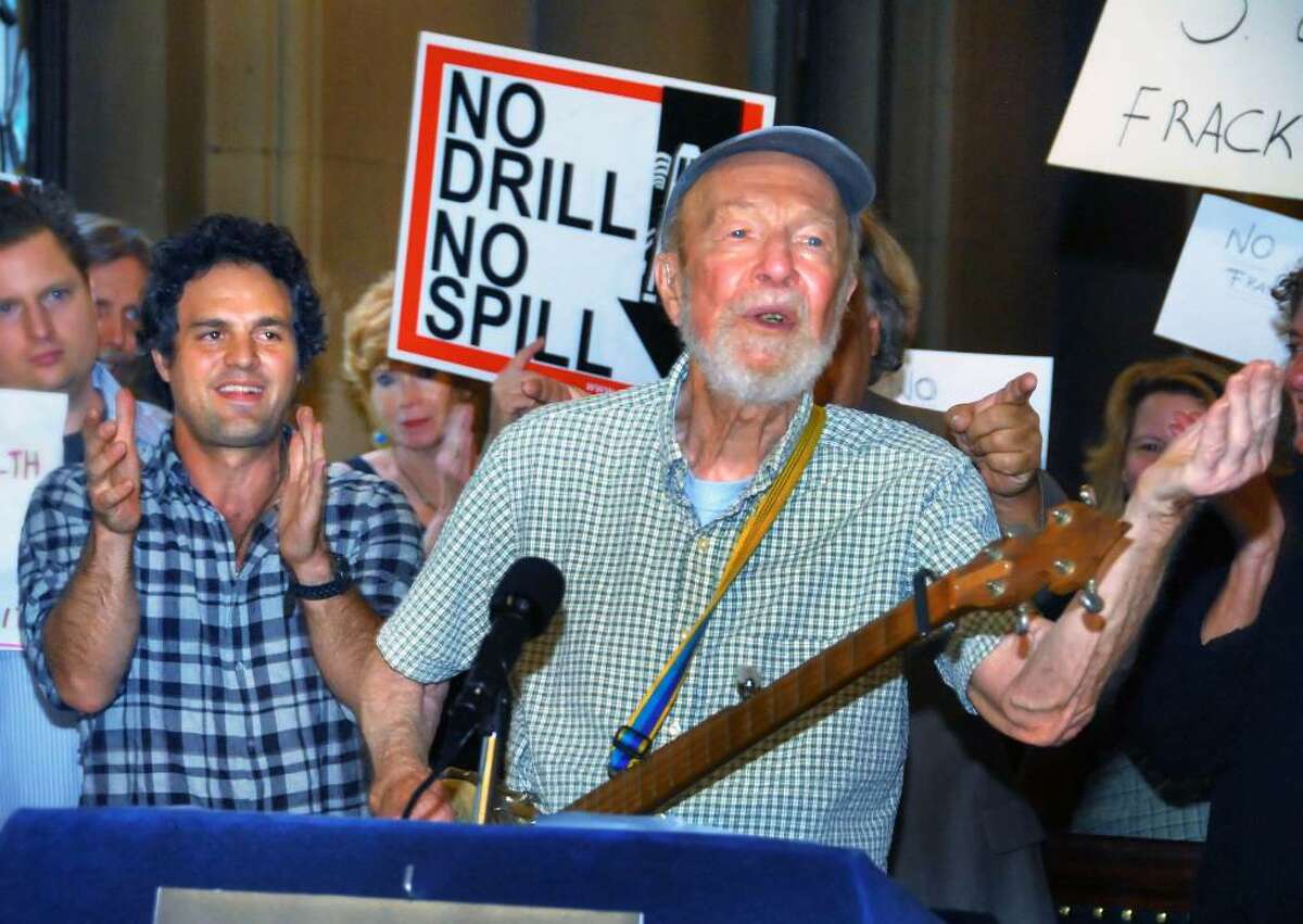 Folk singer and environmental activist Pete Seeger lends his voice to the call for the Legislature to pass a moratorium on shale gas drilling during a news conference Tuesday at the Capitol. Actor Mark Ruffalo, left, also raised environmental concerns, including the threat of water pollution, during the event. (John Carl D'Annibale / Times Union)