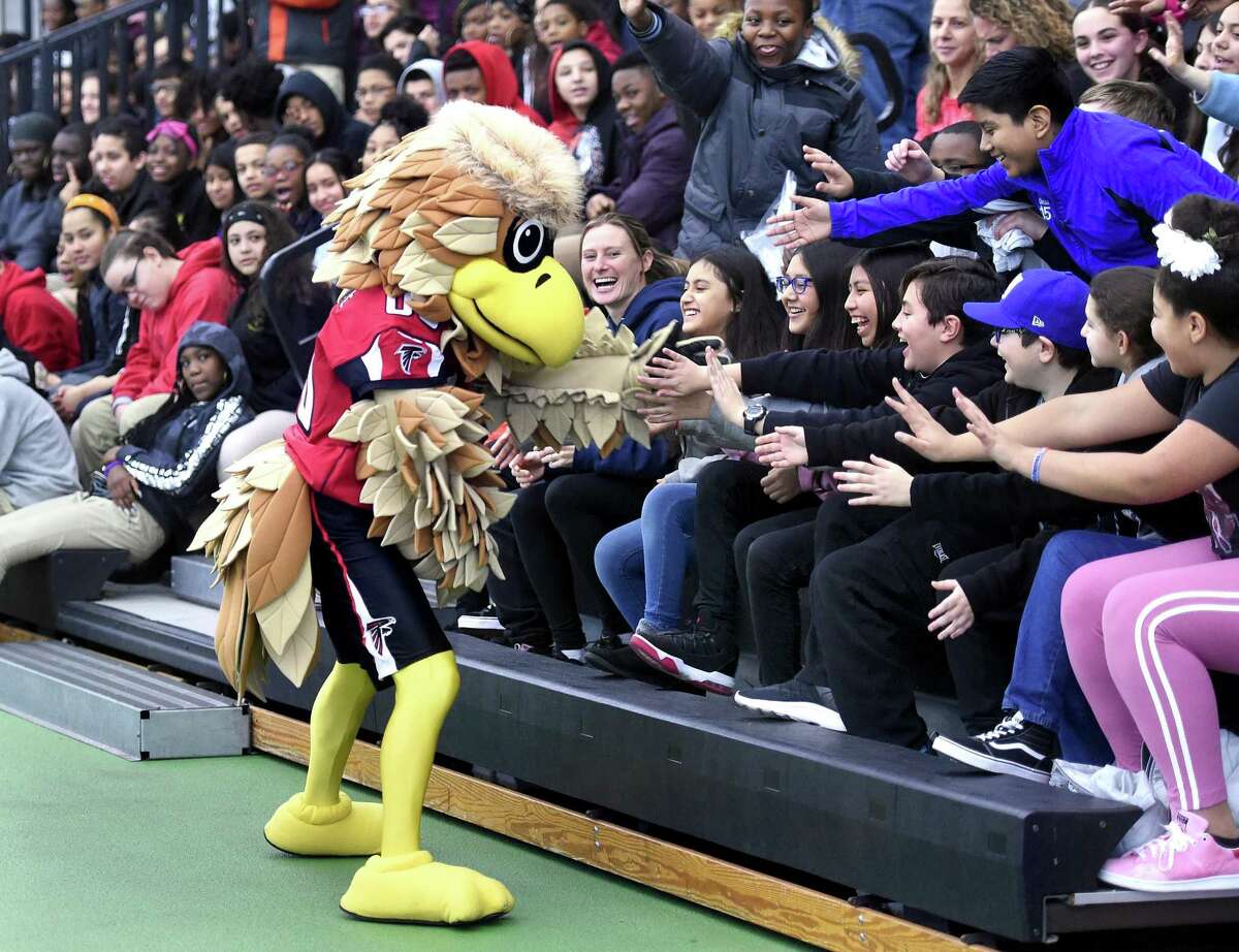 Freddie Falcon, the Atlanta Falcons mascot, mingles with students from Carrigan Intermediate School of West Haven during the Walter Camp Staying in School Rally at the Floyd Little Athletic Center in New Haven on January 10, 2019.