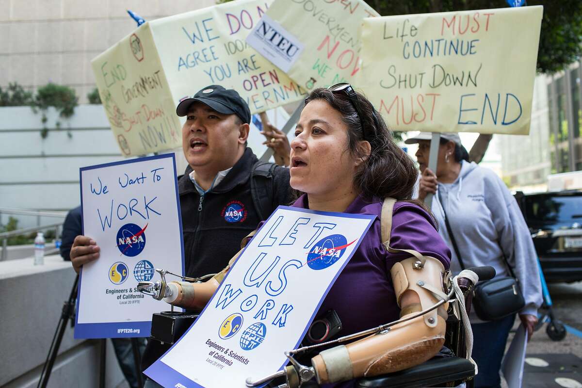 Dana Bolles and Jonas Dino employees of NASA Ames Research Center in Mountain View rally outside the EPA Region 9 Offices in San Francisco to protest the continuing shutdown of the government and resulting furloughs that are financially hurting 800,000 federal employees and families. On Thursday, January 10, 2019. San Francisco, Calif.