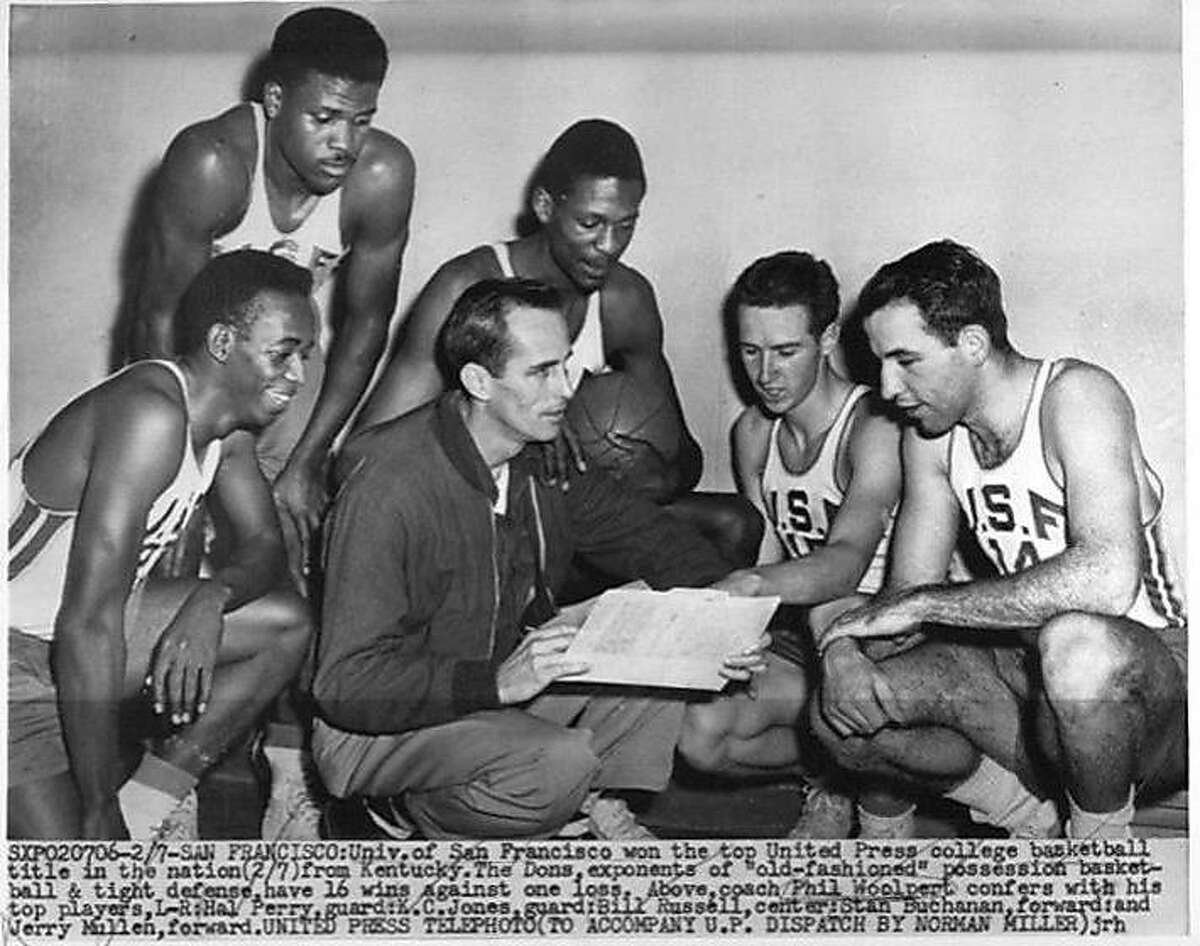 Univ. of San Francisco won the top United Press college basketball title in the nation 2/7 from Kentucky. The Dons, exponents of "old-fashoned" possession basketball and tight defense have 16 wins against one loss. Coach Phil Woolpert confers with his top players: (L-R) Hal Perry, guard; K.C.Jones, guard; Bill Russell, center; Stan Buchanan, forward; and Jerry Mullen, forward.