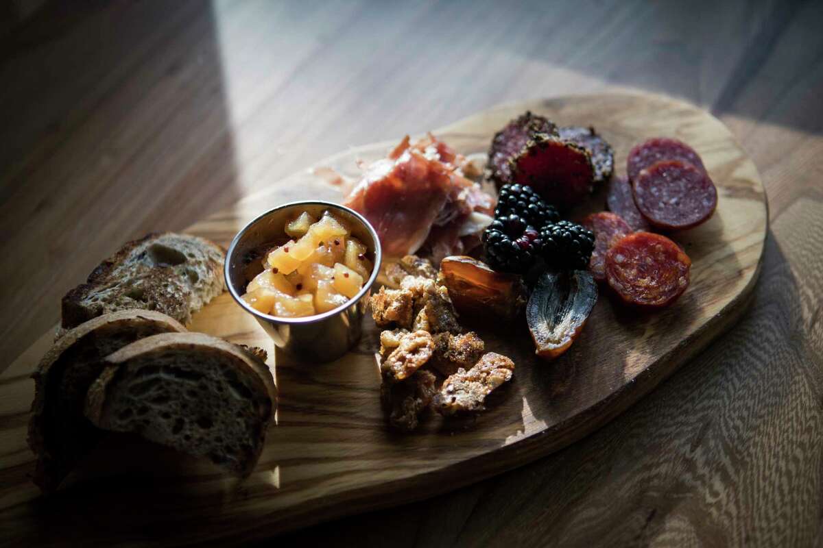 Charcuterie board with three different meats, fruit preserve, house pickles and spiced nuts at Decatur Bar & Pop-Up Factory, 2310 Decatur.