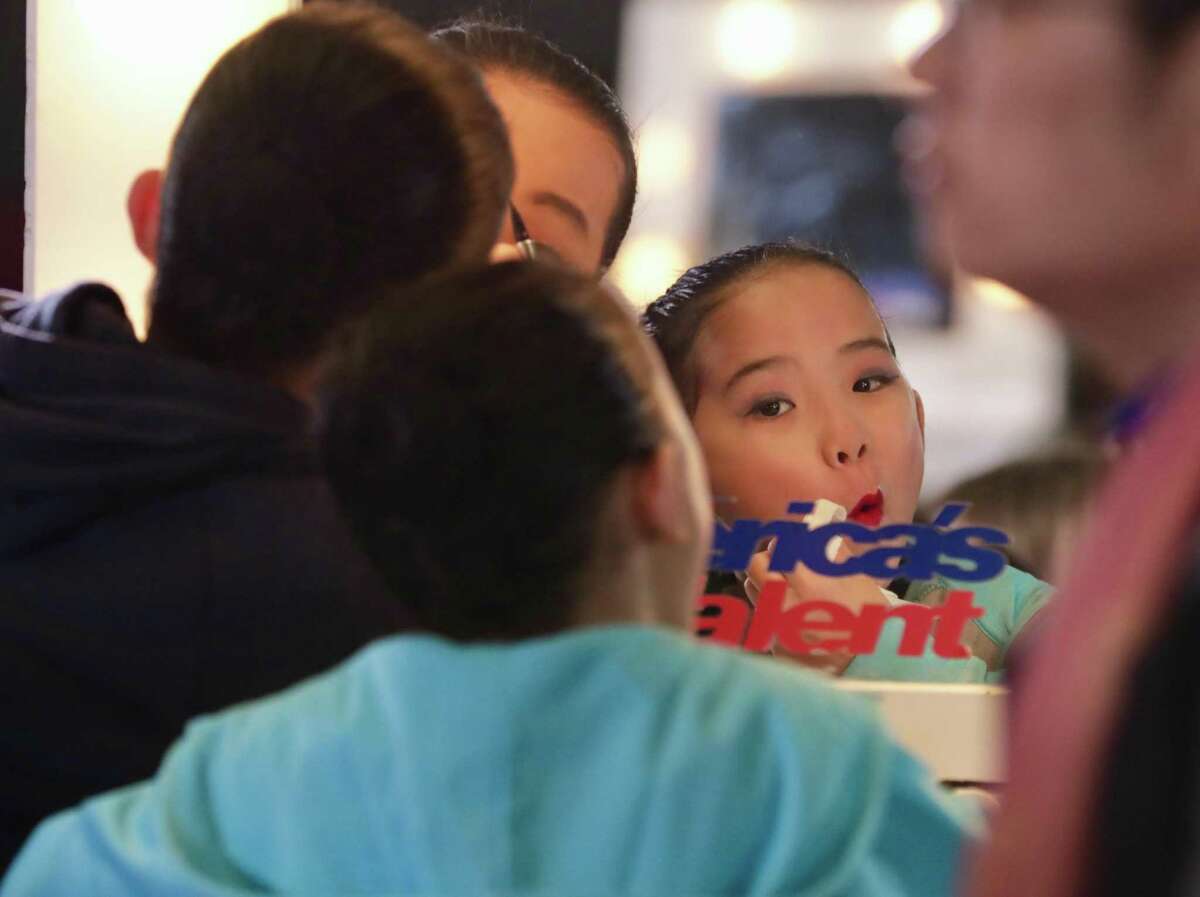 Emma Zeng, 11, from Houston, checks her makeup before her dance group auditions for “Americas Got Talent.” Winners receive a grand prize of $1 million and the opportunity to appear in a Las Vegas show.