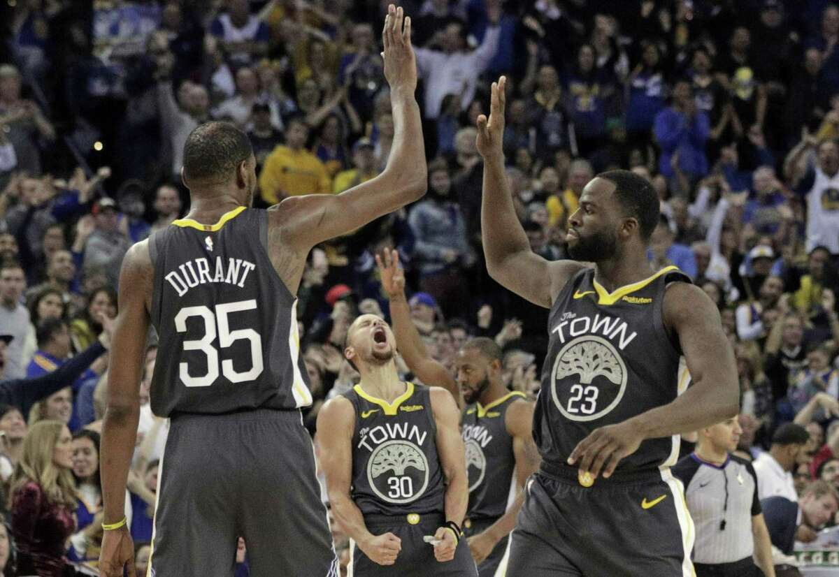 The Warriors celebrate a three point shot by Kevin Durant (35) to put the Warriors ahead in the second half as the Golden State Warriors played the Los Angeles Clippers at Oracle Arena in Oakland, Calif., on Sunday, December 23, 2018.