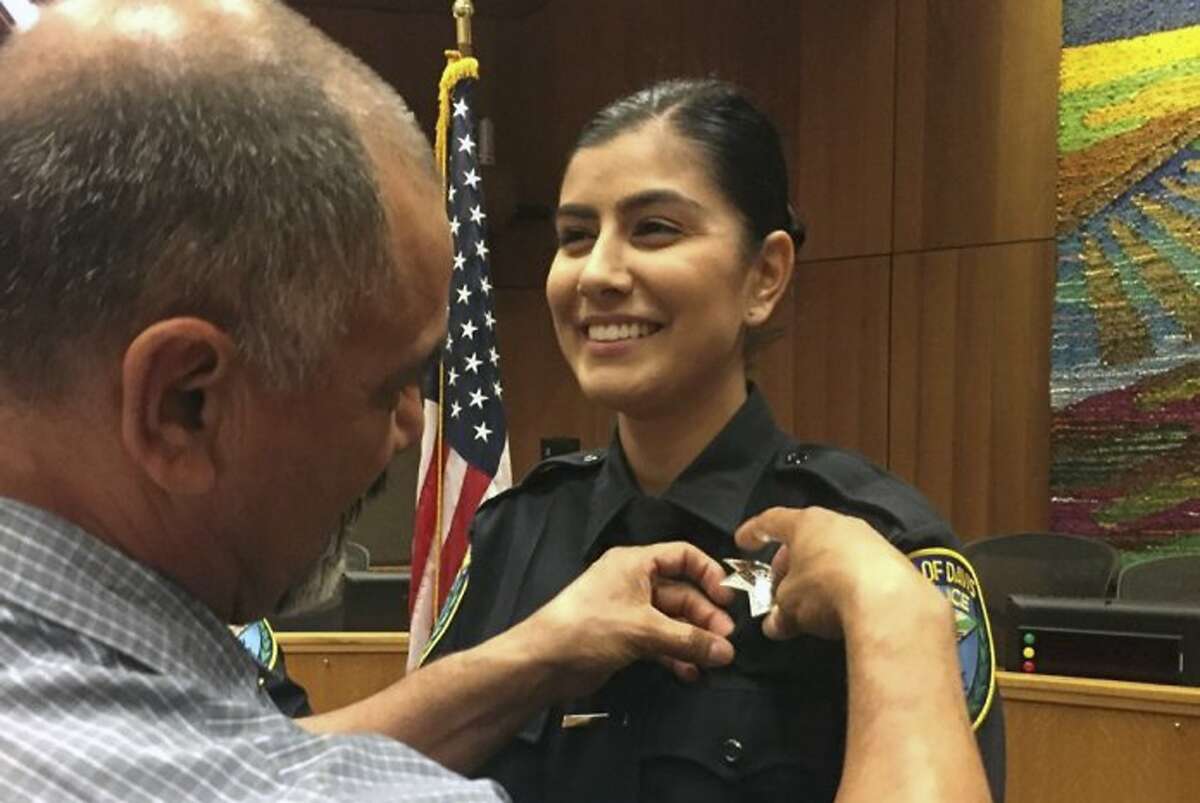 This Aug. 2, 2018 photo provided by Williams Pioneer Review shows Merced Corona, left, pins his daughter Natalie Corona's badge on her uniform during a swearing-in ceremony in Davis, Calif. Natalie Corona was shot and killed during a routine call Thursday, Jan. 10, 2019. (Williams Pioneer Review via AP)