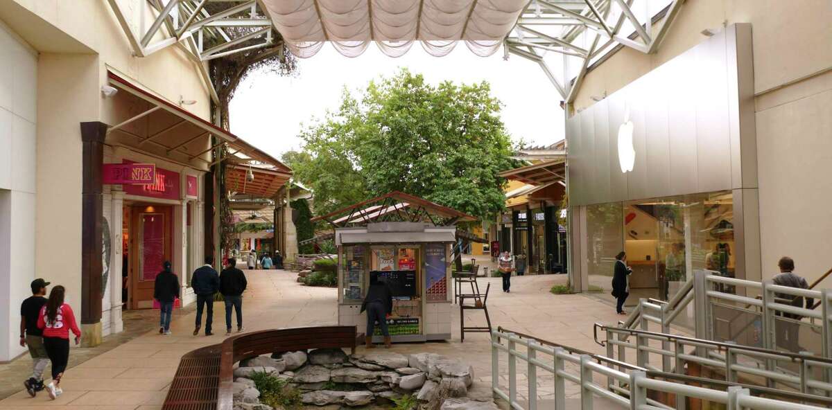 Shoppers stroll at The Shops at La Cantera, before the coronavirus forced most of the stores to close