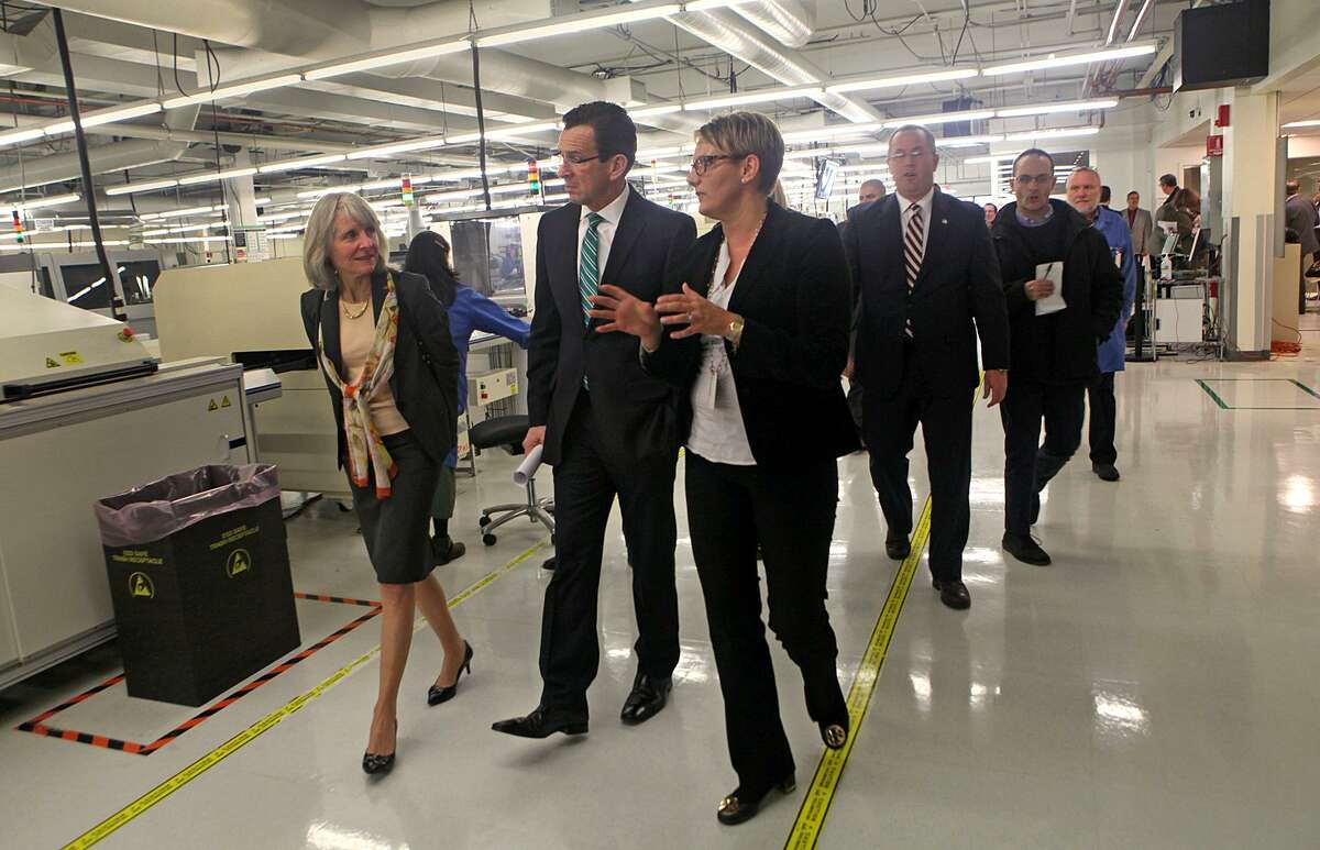 Former Connecticut Gov. Dannel P. Malloy on a 2014 tour of Microboard Processing in Seymour, among some 1,900 companies to receive state financing under Malloy’s Small Business Express program.