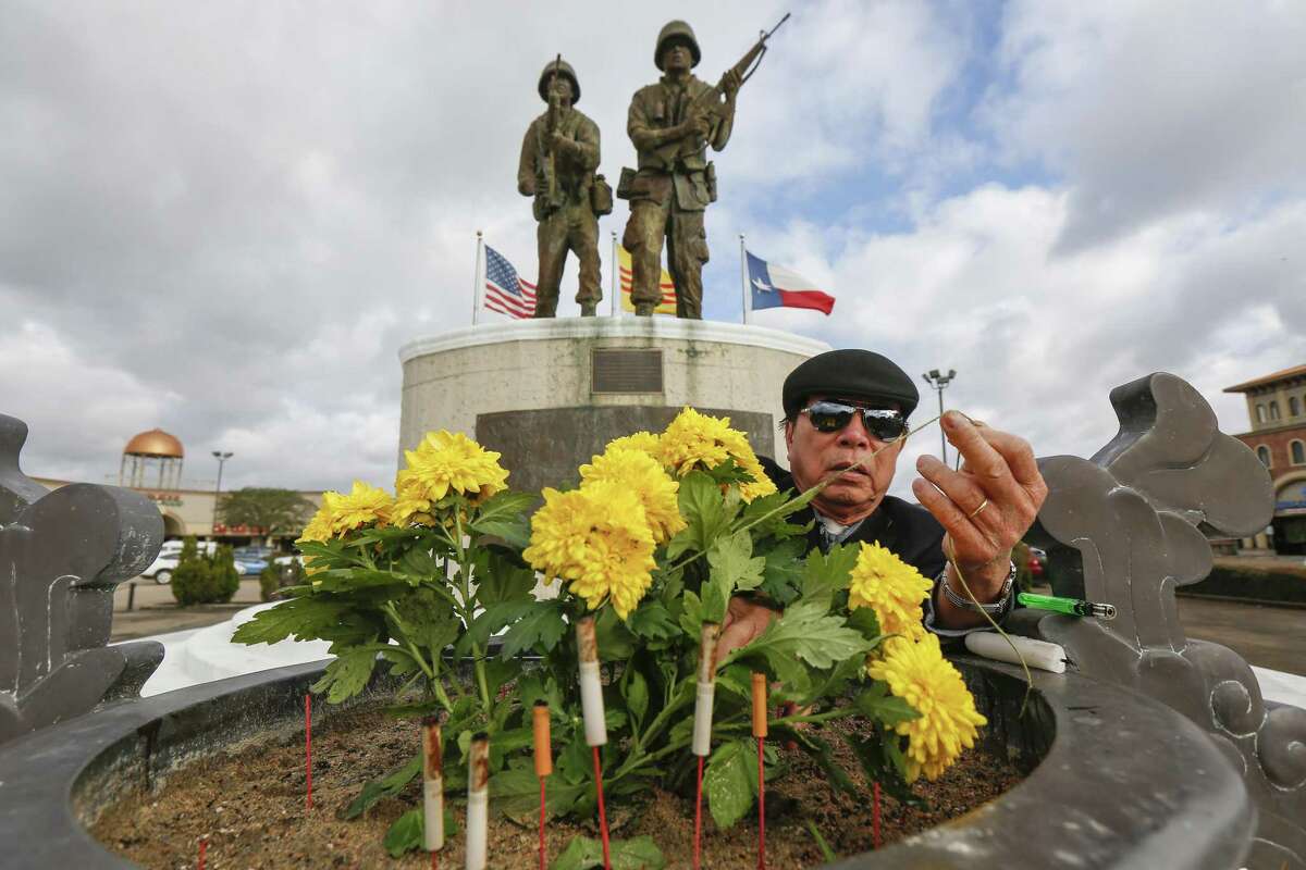 Thu Ngo prepares the flowers in front of the Vietnam Memorial before a rally held by HAAPI Youth and community partners Saturday, Jan. 12, 2019, in Houston. The rally was held in light of the United States Administration's heightened attacks to deport impacted Vietnamese and Southeast Asian communities and renegotiating the 2008 United States - Vietnam Repatriation Agreement?.