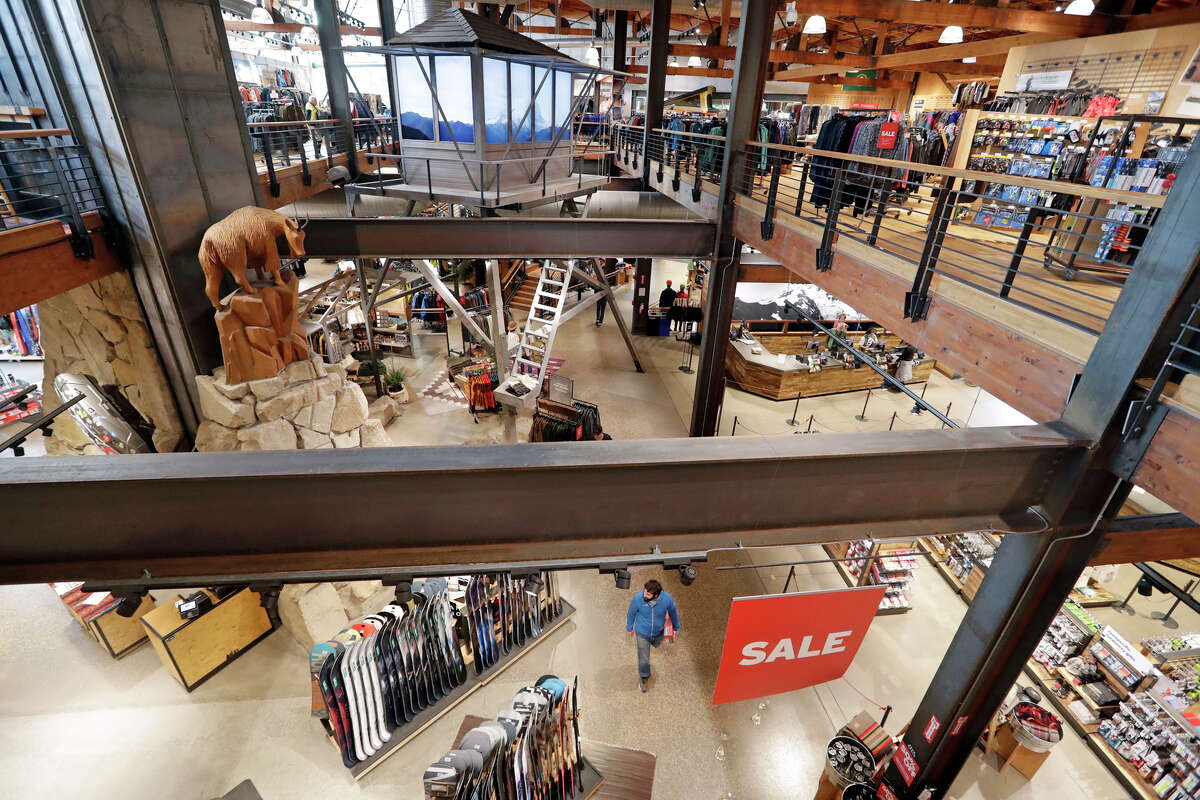 FILE- In this Nov. 13, 2018, file photo a carved mountain goat looks down at the lower level in REI Co-op's flagship store in Seattle.