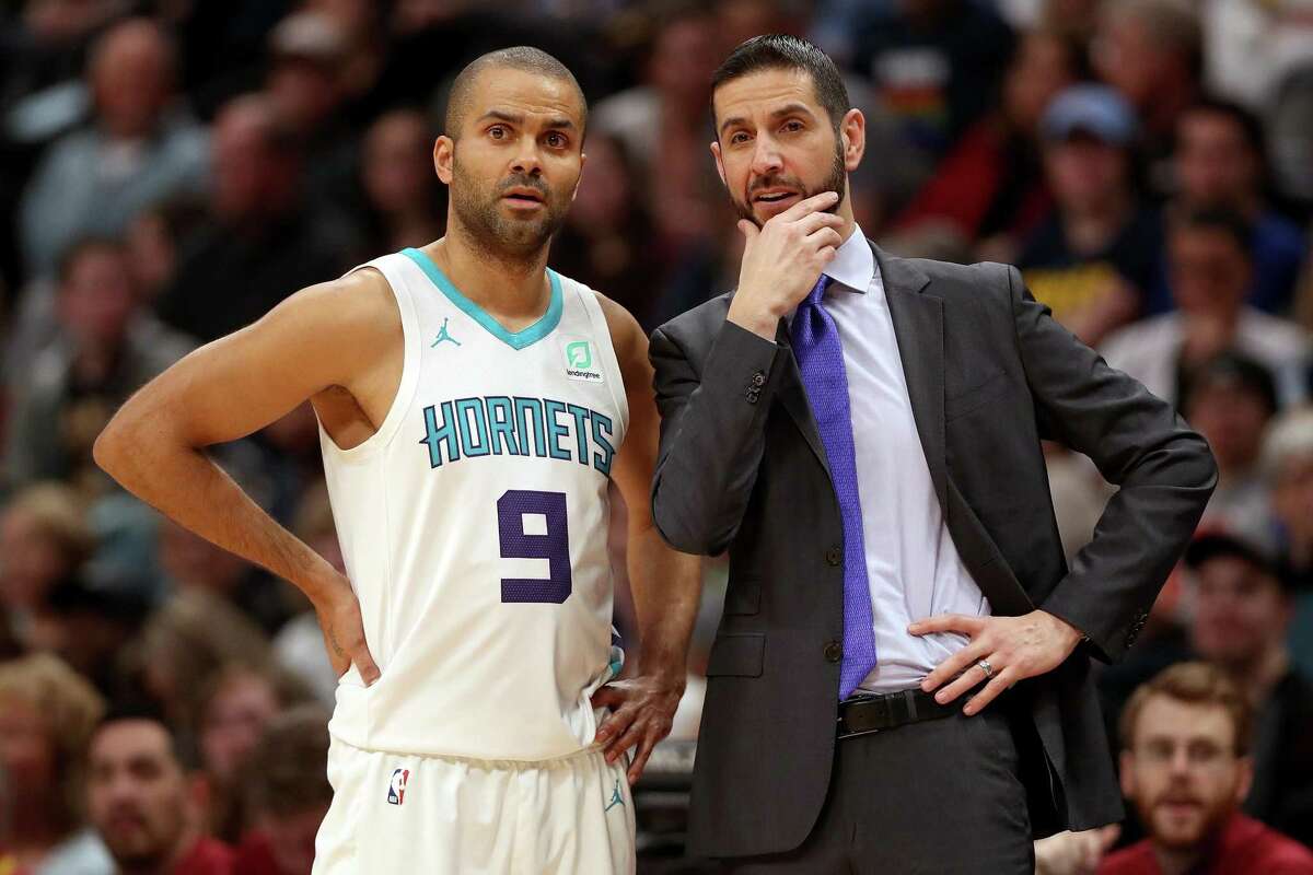 DENVER, COLORADO - JANUARY 5: Tony Parker #9 of the Charlotte Hornets confers with head coach James Borrego in the first quarter against the Denver Nuggets at the Pepsi Center on January 5, 2019 in Denver, Colorado. (Photo by Matthew Stockman/Getty Images)