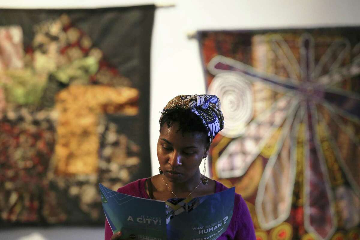 Selena Mitchell stands near an exhibit of textile-based art known as Bitik at the Olaju African Market Creative Arts Festival which showcases arts from the African continent at the Blue Star Arts Complex on Saturday, Jan. 12, 2019. As one of the officially recognized events of DreamWeek which promotes the teachings of Dr. Martin Luther King, the Olaju Festival provides enlightenment of African art and culture to San Antonio. (Kin Man Hui/San Antonio Express-News)