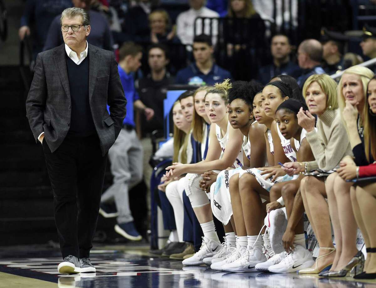 All five UConn starters sit on the bench after coach Geno Auriemma, left, pulled them early in the first half on Sunday.