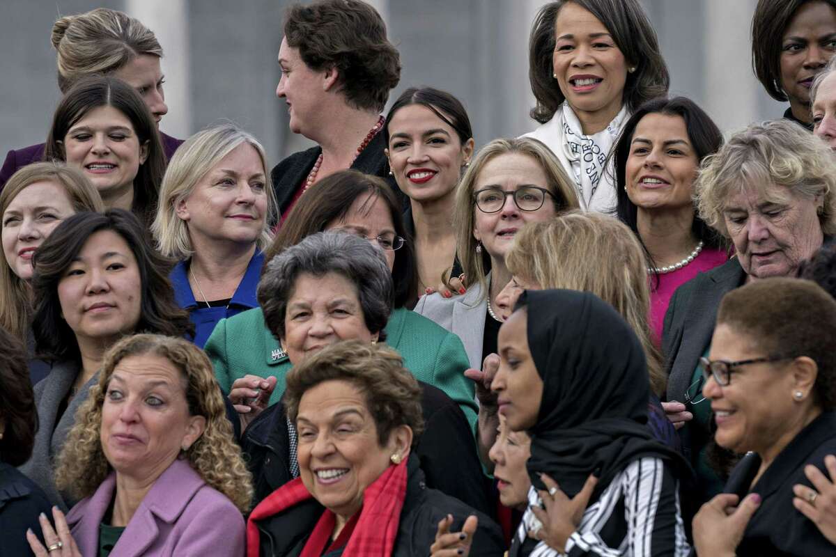 Rep. Alexandria Ocasio-Cortez, D-N.Y. (top center) stands for a photograph with House Democratic women members of the 116th Congress in Washington on Jan. 4, 2018.