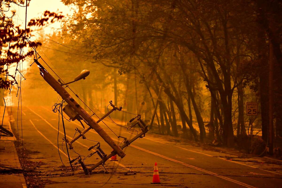 A downed telephone pole off of Elliott Road after the Camp Fire tore through the town of Paradise, California, on Friday, Nov. 9, 2018.