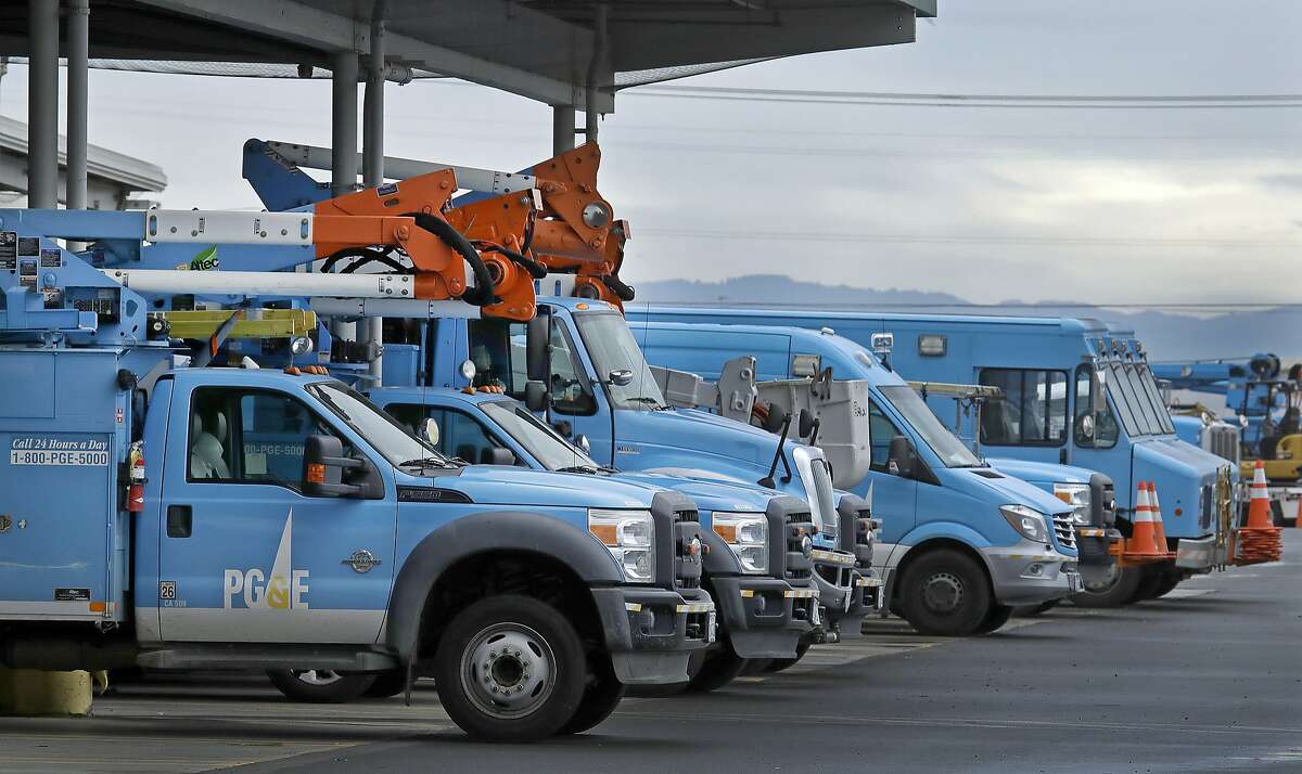 Pacific Gas & Electric vehicles are parked at the PG&E Oakland Service Center, Monday, Jan. 14, 2019, in Oakland, Calif. Facing potentially colossal liabilities over deadly California wildfires, PG&E will file for bankruptcy protection. The announcement today follows the resignation of the power company's chief executive. (AP Photo/Ben Margot)