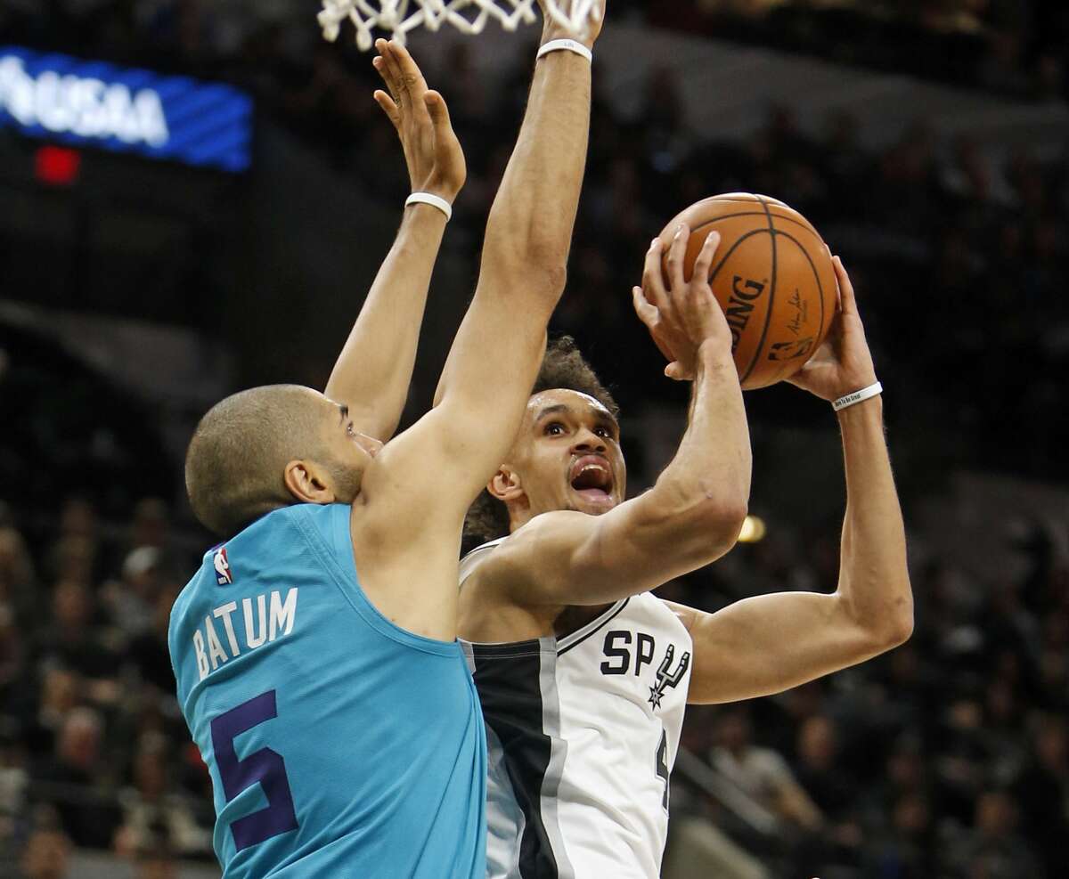 Derrick White #4 of the San Antonio Spurs shoots over Nicolas Batum #5 of the Charlotte Hornets on Monday, January 14, 2019 at AT&T Center.