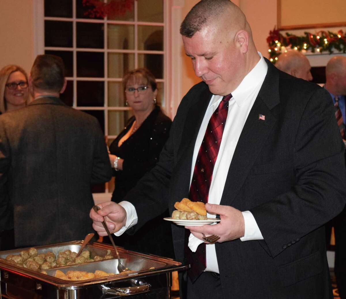 First Lieutenant Brian Bollaro serves up appetizers at the start of the annual event.