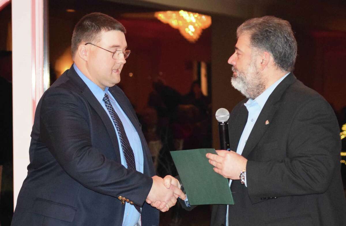 New Milford Mayor Pete Bass, right, congratulates David Golembeski with a special proclamation, recognizing his efforts to secure $1.2 million in fire department grants for the community.