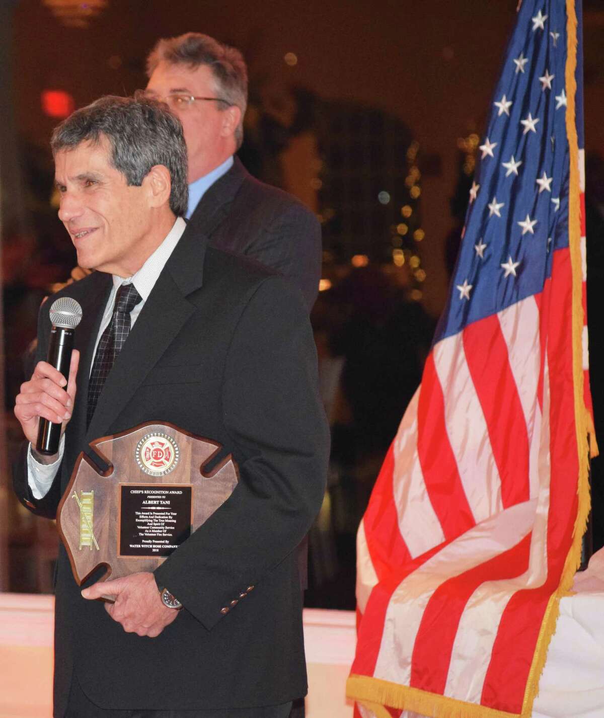 Member Al Tani graciously accepts the Chief's Award, presented by Fire Chief James Ferlow, back, at Water Witch Hose Co. #2's annual dinner.