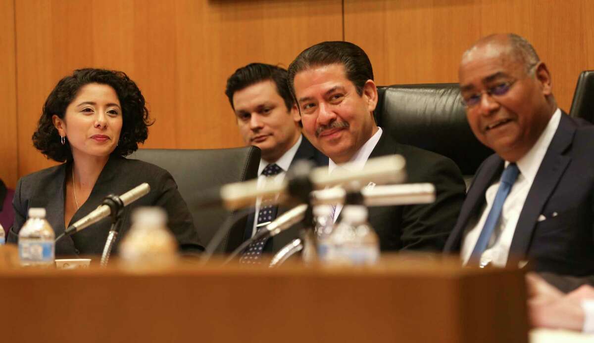 Harris County Judge Lina Hidalgo, left, commissioners Adrian Garcia and Rodney Ellis, shown here in January, voted Tuesday to divide Metro funding evenly among the county's four precincts.