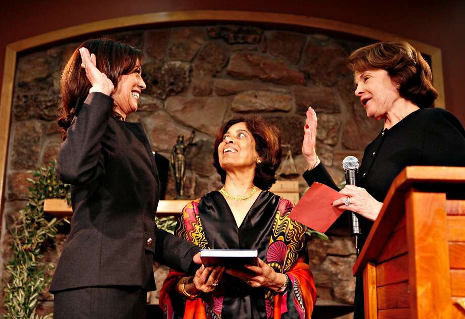 District Attorney Kamala Harris (left) is sworn in by US Senator Dianne Feinstein (right). In the center is Kamals's mom Shymala Harris. District Attorney Kamala Harris is sworn in to a second term in office after garnering more than 98% of the vote in the first uncontested race for District Attorney of San Francisco since 1991. US Senator Dianne Feinstein administered the oath of office. Ceremony took place at fhe Delancey Street Town Hall. Photo taken on 1/8/08 in San Francisco, CA. Photo by Michael Maloney / San Francisco Chronicle ***Kamala Harris, Dianne Feinstein, Shymala Harris, Gavin Newsom, Willie Brown Photo: Michael Maloney / The Chronicle 2008